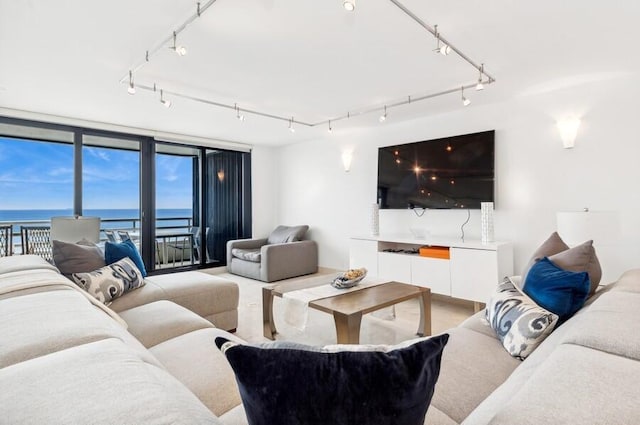 living room with a water view and track lighting