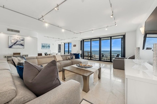 living room with a water view and track lighting