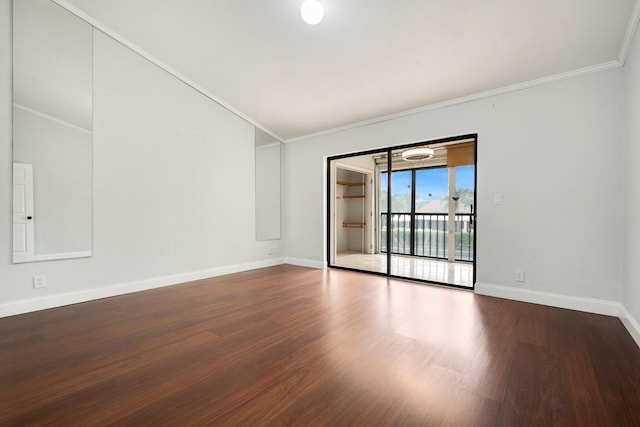 empty room with crown molding and hardwood / wood-style floors