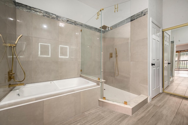 bathroom featuring hardwood / wood-style flooring and independent shower and bath