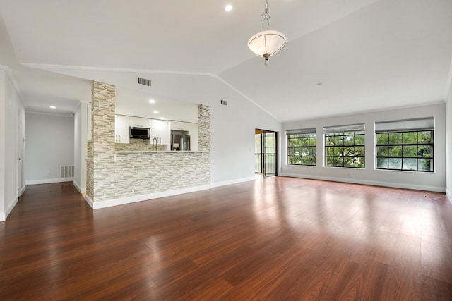 unfurnished living room featuring dark hardwood / wood-style flooring, ornamental molding, sink, and high vaulted ceiling