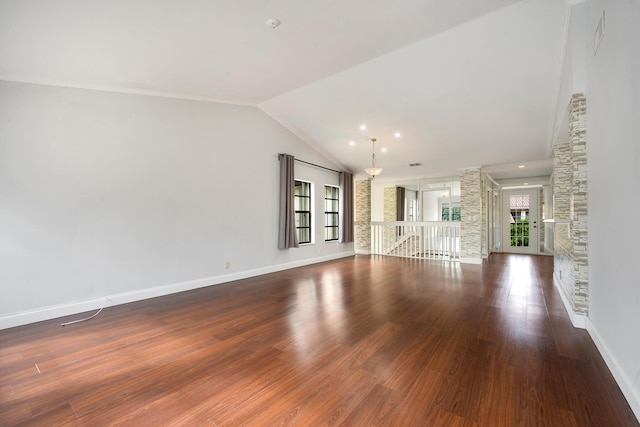 unfurnished living room with french doors, dark wood-type flooring, and vaulted ceiling