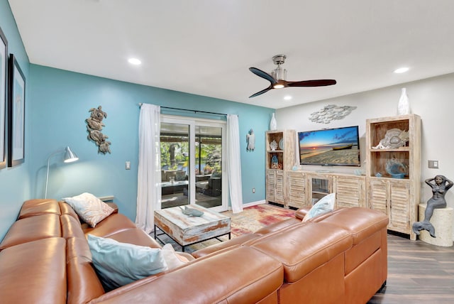 living room with ceiling fan and hardwood / wood-style floors