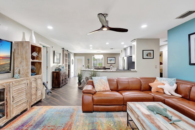 living room featuring hardwood / wood-style floors and ceiling fan