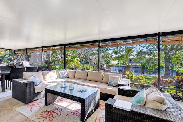 sunroom featuring a wealth of natural light and a water view