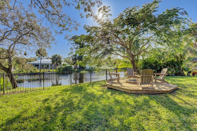 view of yard featuring a water view and a fire pit