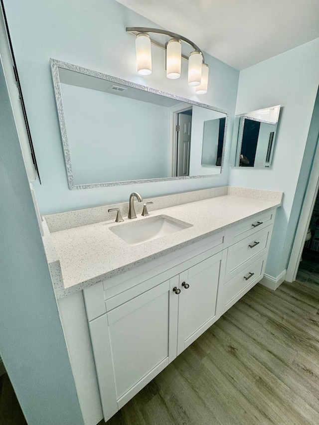 bathroom featuring wood-type flooring and vanity