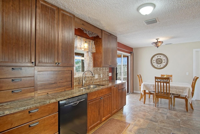 kitchen with dishwasher, sink, light stone countertops, tasteful backsplash, and decorative light fixtures