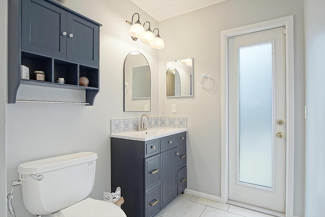 bathroom with tile patterned floors, vanity, and toilet