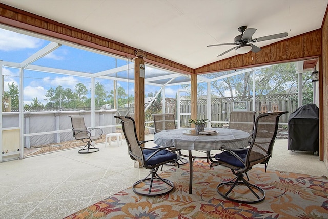 sunroom / solarium with ceiling fan, a healthy amount of sunlight, and lofted ceiling