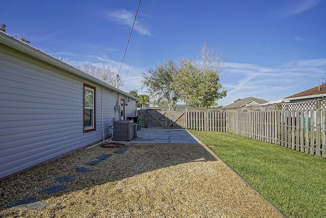 view of yard featuring central AC unit and a patio area