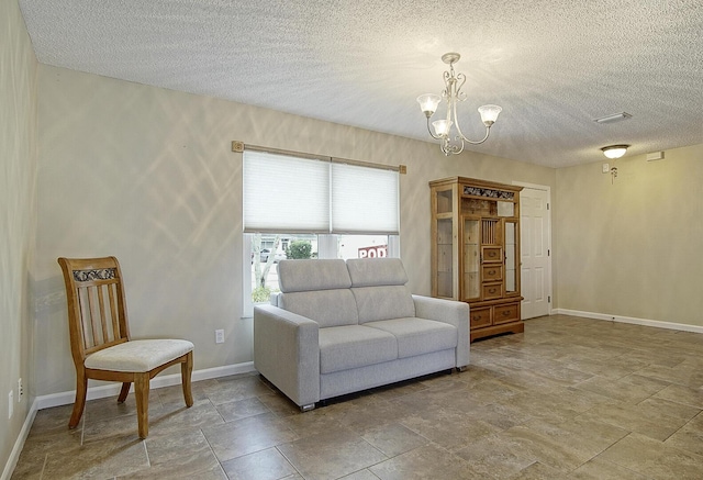 sitting room with a textured ceiling and a notable chandelier