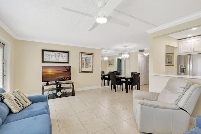 tiled living room with ceiling fan, a textured ceiling, and ornamental molding