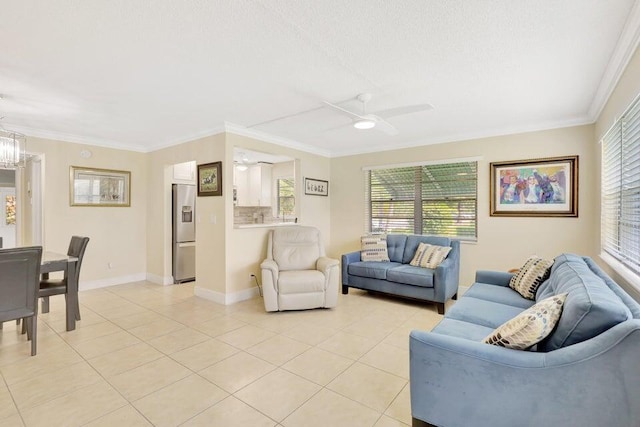 tiled living room with ceiling fan with notable chandelier and ornamental molding