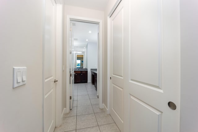 hall featuring light tile patterned floors