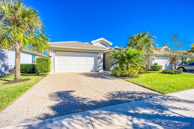 ranch-style home with a front lawn and a garage