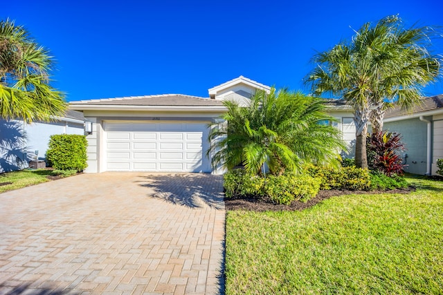 view of front of house featuring a front yard and a garage