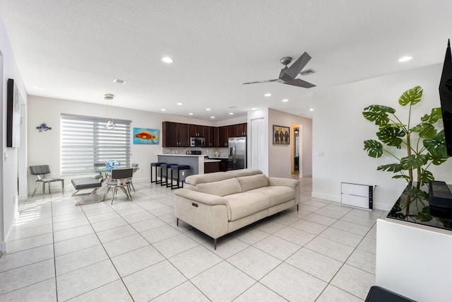 living room featuring ceiling fan and light tile patterned flooring