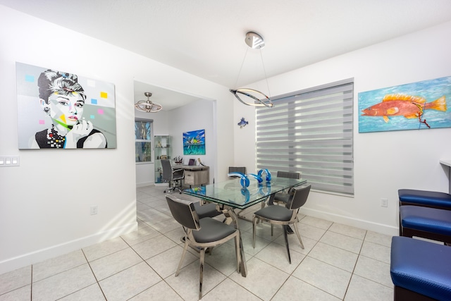 tiled dining area featuring a notable chandelier