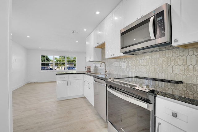 kitchen featuring sink, white cabinets, and appliances with stainless steel finishes