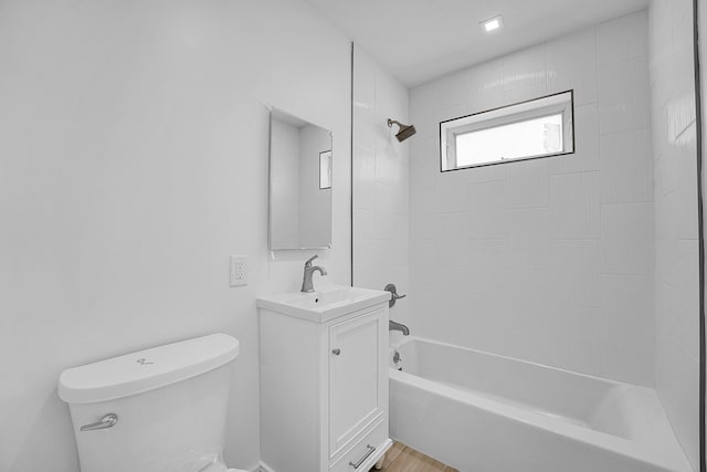 full bathroom featuring vanity, toilet, and tiled shower / bath