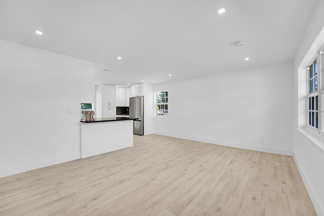 unfurnished living room with light hardwood / wood-style floors