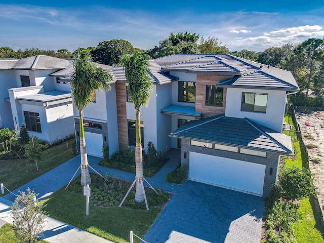18416 Symphony Ct, Jupiter, FL 33458 - view of front of house with stucco siding, a tiled roof, and decorative driveway