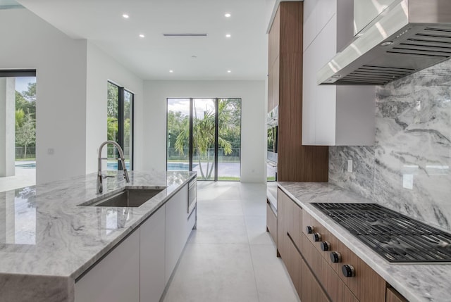 18416 Symphony Ct, Jupiter, FL 33458 - kitchen with extractor fan, modern cabinets, a sink, appliances with stainless steel finishes, and recessed lighting