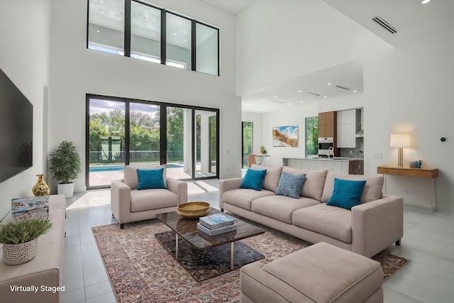 18416 Symphony Ct, Jupiter, FL 33458 - living room featuring a high ceiling, plenty of natural light, light tile patterned floors, and recessed lighting