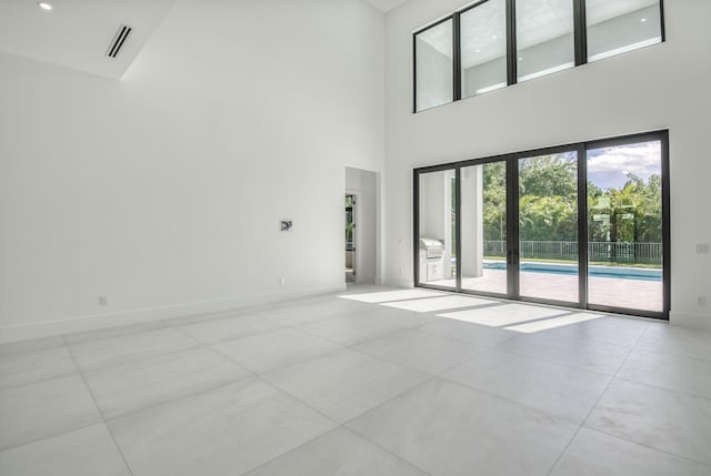 18416 Symphony Ct, Jupiter, FL 33458 - unfurnished living room with a high ceiling and baseboards