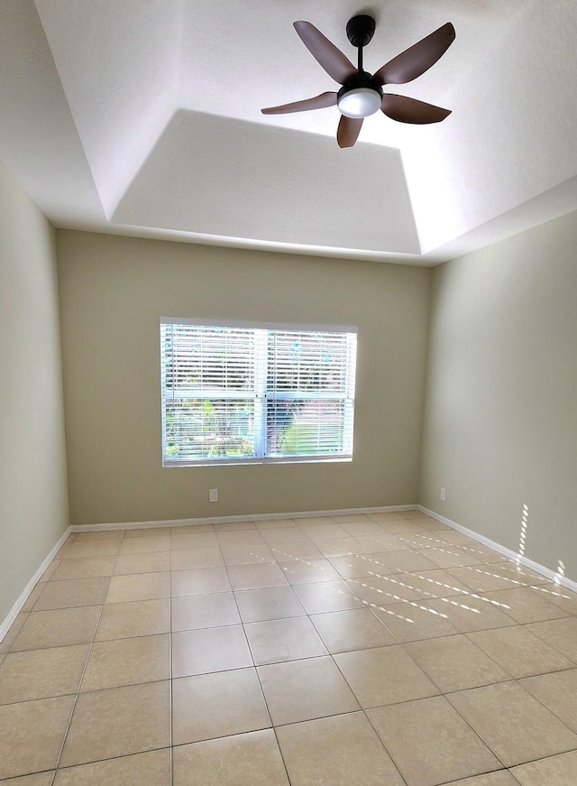 empty room with ceiling fan and light tile patterned floors