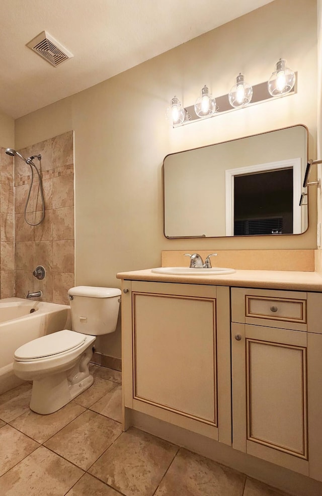 full bathroom with tile patterned flooring, vanity, tiled shower / bath combo, and toilet