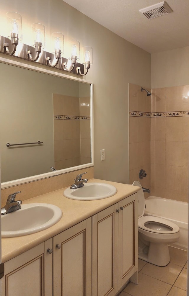 full bathroom with tile patterned floors, vanity, toilet, and tiled shower / bath