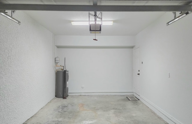 garage featuring electric water heater and a garage door opener