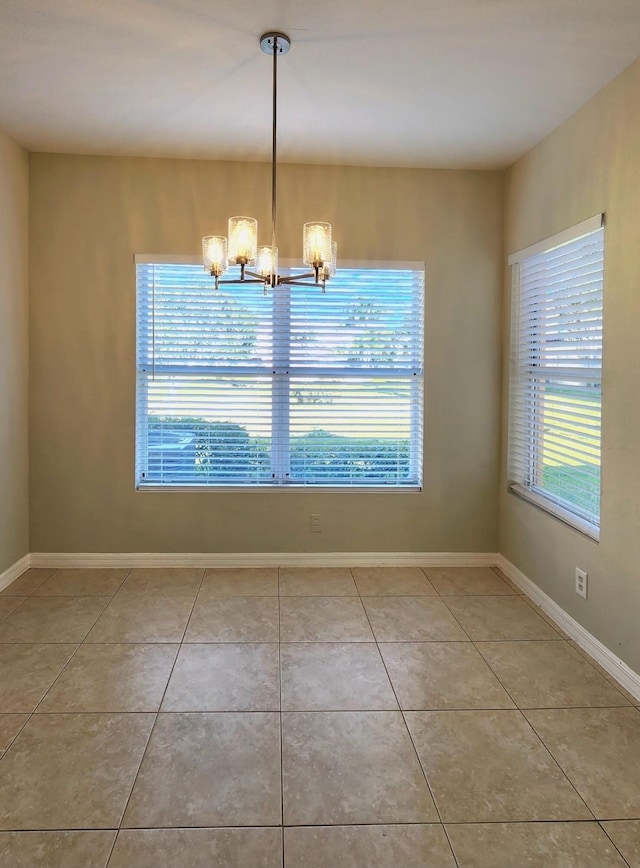 unfurnished dining area with light tile patterned flooring and a chandelier