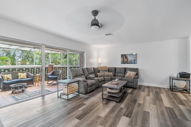 living room with ceiling fan and wood-type flooring