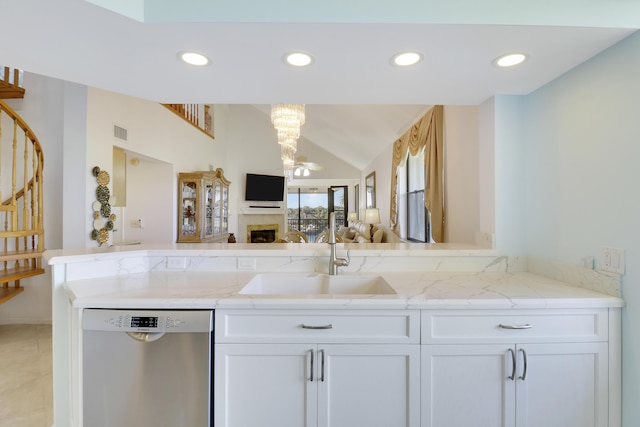 kitchen featuring white cabinetry, dishwasher, light stone countertops, and sink