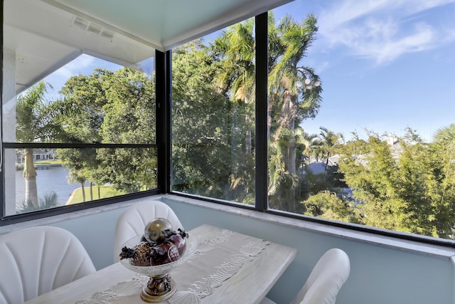 unfurnished sunroom with a water view