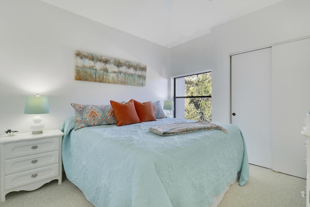 carpeted bedroom featuring ceiling fan and a closet