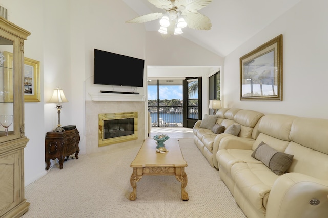 living room featuring a fireplace, ceiling fan, light carpet, and high vaulted ceiling