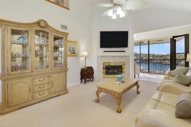 living room with ceiling fan, light colored carpet, and lofted ceiling