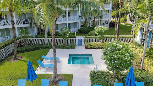 view of pool with a patio area and a yard