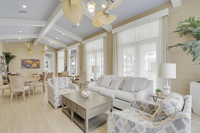 living room with lofted ceiling with beams, ceiling fan, and light hardwood / wood-style flooring