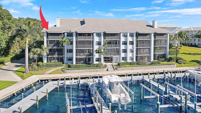 545 Bay Colony Dr N, Juno Beach, FL 33408 - view of building exterior featuring boat lift and a water view
