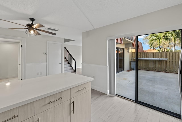 kitchen with a textured ceiling and ceiling fan