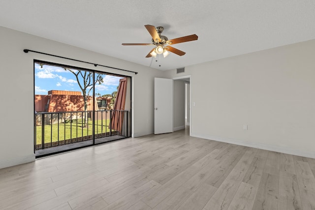 spare room featuring ceiling fan, a textured ceiling, and light hardwood / wood-style flooring