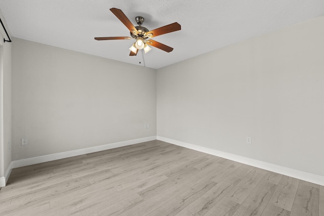 empty room with a textured ceiling, light hardwood / wood-style floors, and ceiling fan