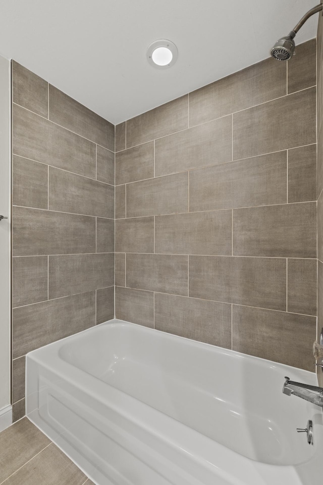 bathroom with tile patterned floors and tiled shower / bath combo