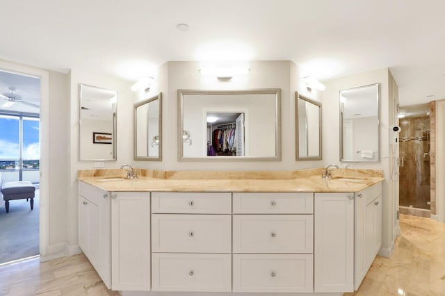 bathroom with vanity and tiled shower