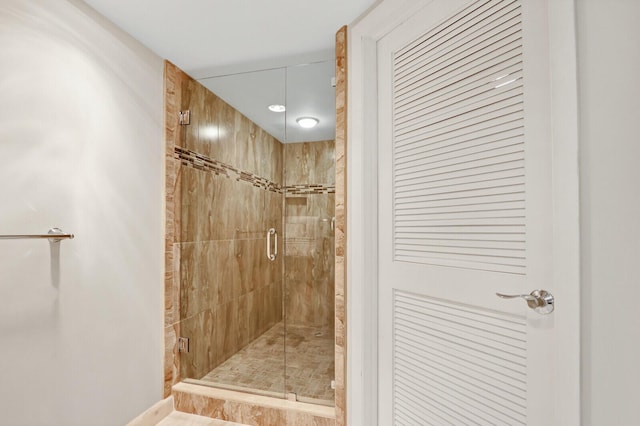 bathroom with a shower with door